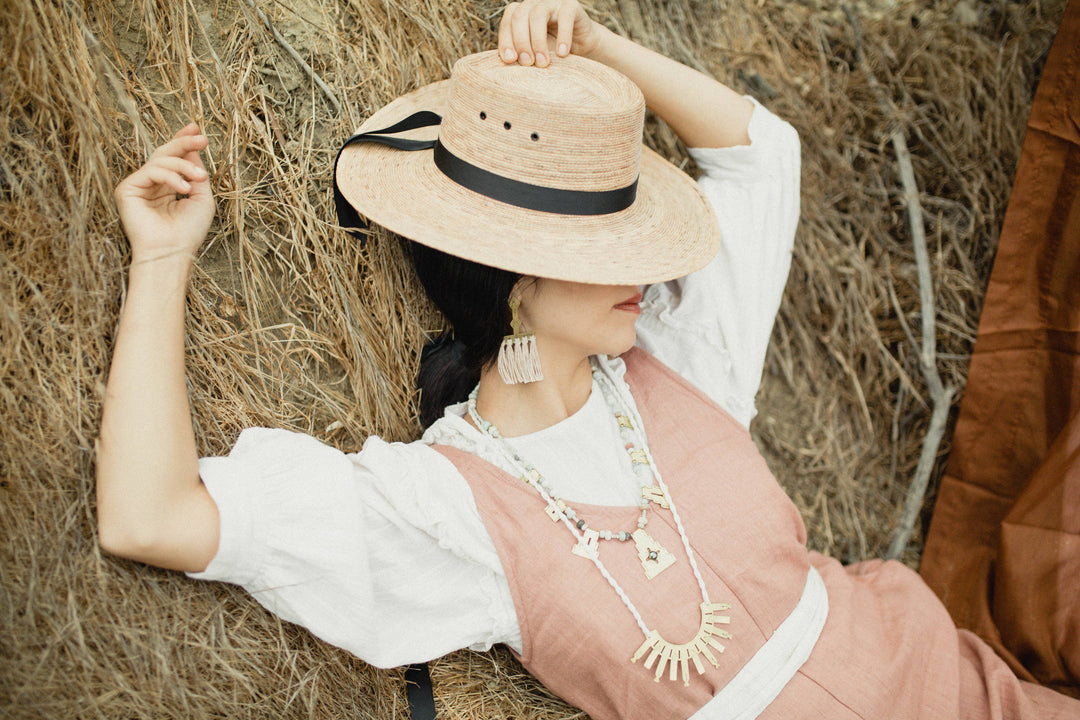 model wearing hat, jewlery and necklace austin small business owned business