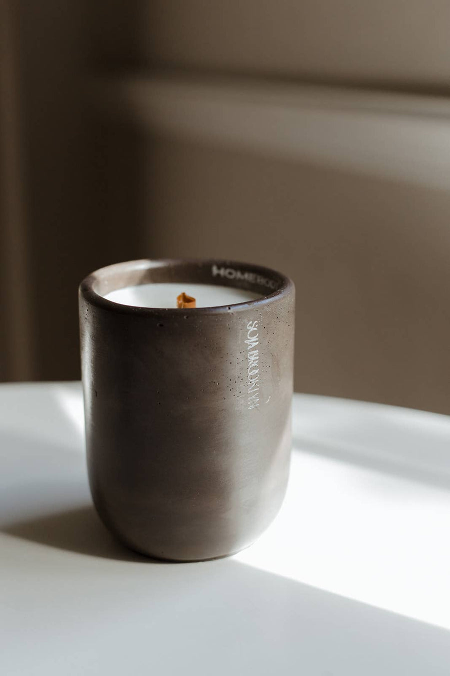 Mood: Warm + Cozy Homebody offers a consummate combination of tobacco and santal, evoking an ambience of comfort with its whispers of vanilla. handcrafted candle in cement vessel